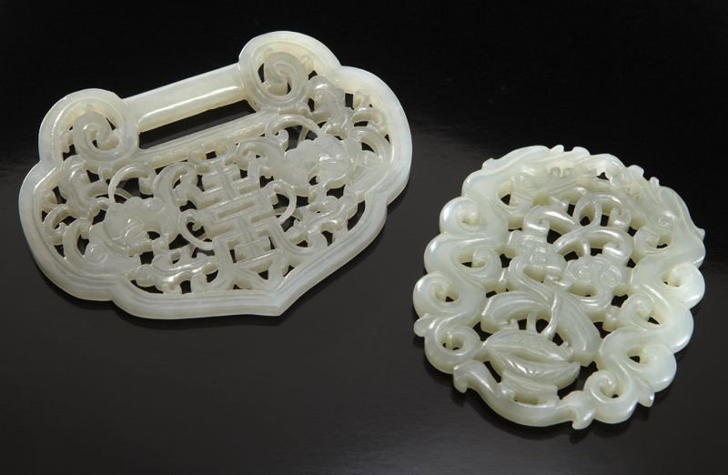 (2) Chinese Qing jade carvings:: (1) lock depicting bats and longevity; (1) pendant depicting double lingzhi and two dragons. Largest: 3.25"W, Circa - 18th - 19th C.