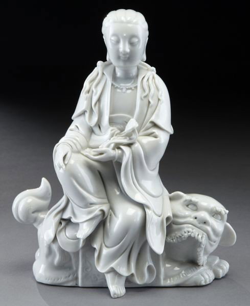 Chinese Qing blanc de chine Guanyin: holding a ruyi scepter in her hand, riding a lion. Seal mark on back. 8.5"H, Circa - 19th C.