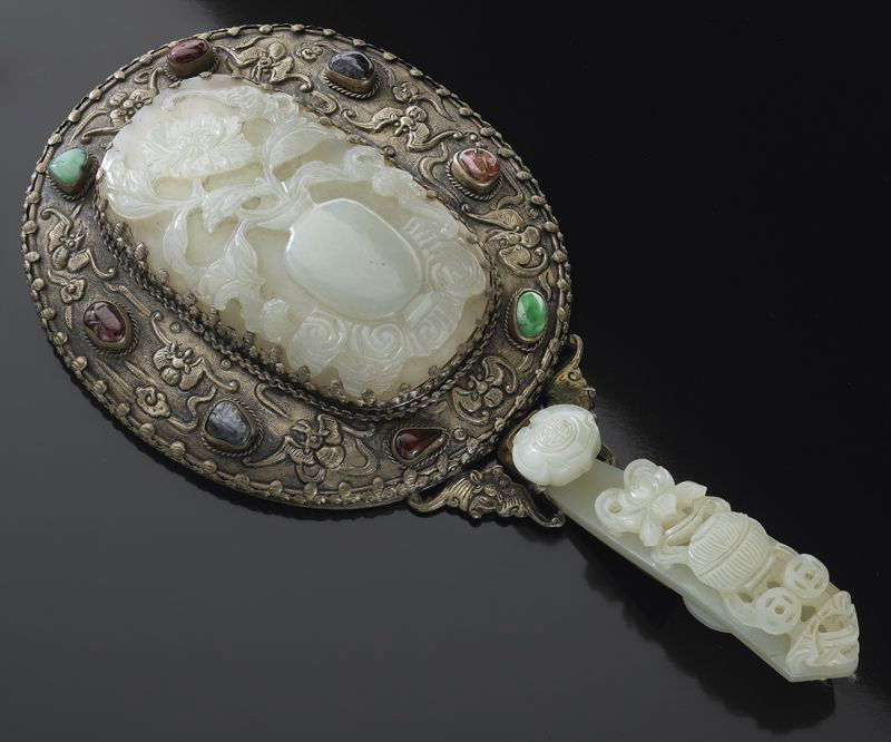 Chinese Qing silver mounted jade mirror.: the plaque depicting peony in a vase, 4.25"H x 2.5"W, the jade handle in ruyi shape depicting lotus, 4"L, the mirror mounted with six jadeite and tourmaline beads, Overall: 9.5"H, Circa - 18th - 19th
