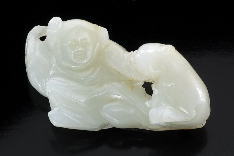 Chinese Qing carved white jade boy: playing with a dog, the jade with russet skin. 2"H x 1.125"W, Circa - 19th C.