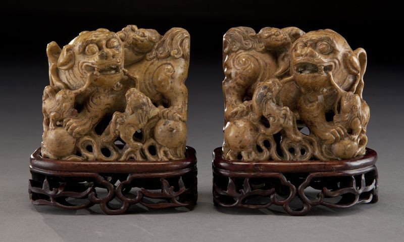 Pr. Chinese Qing carved soapstone foo dogs,: raised on carved wood stands. 3.25"H x 3.25"W, Circa - 19th C.