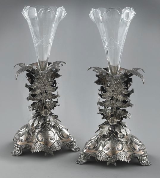 Pr. Mappin and Webb silver plate epergnes: with glass inserts, the central columns formed by branches of leaves and flowers, the base raised on three scrolled feet. Stamped on underside, "Mappin and Webb London Sheffield". 15''H, Circa - 1900.