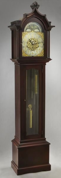 Bawo and Dotter mahogany tall case clock: having a unusual cyma reverse arched bonnet crested by a fleur-de-lis, above columnar supports and glazed arched door enclosing a German Bawo and Dotter three train brass movement chiming on 6 Elite t