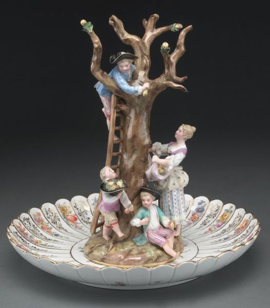 Meissen porcelain figural group, "The Apple: Pickers", together with a Meissen porcelain plate with scalloped rim and floral decoration. Both with cross swords mark in blue under glaze, as well as incised and over glaze numerals. Figure: 9.25''H