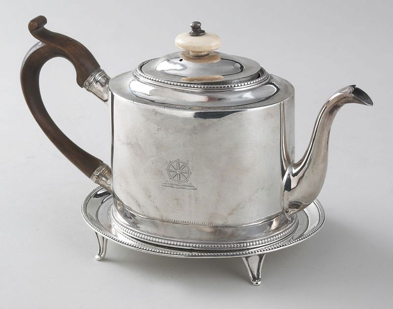Hester Bateman sterling silver teapot on stand.: The teapot with wood handle and ivory finial having a water wheel motif, the associated stand adorned with ribbon and wreath. Marked for Hester Bateman, London; teapot "1778", stand "1787". 16.55 ozt.