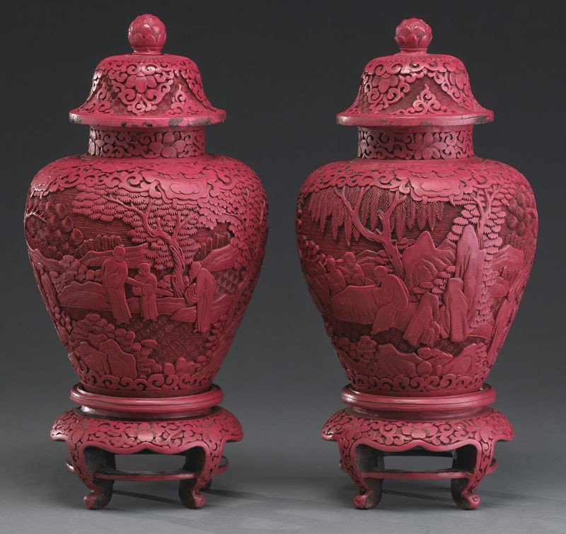 Pr. Chinese Qing carved cinnabar jars: depicting monks in a landscape, with lotus finials and cinnabar bases. 15"H, Circa - 19th C.