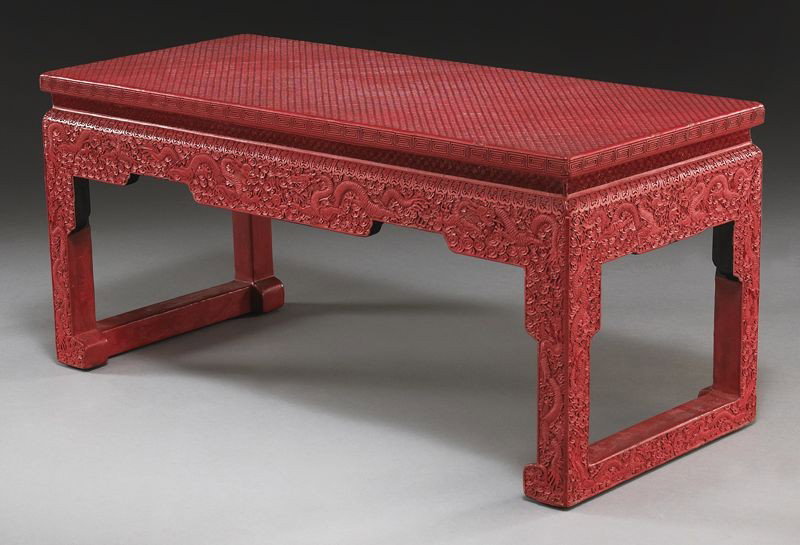 Chinese carved cinnabar coffee table: depicting dragons chasing the flaming pearl. 15.25"H x 33.25"W x 14.25"D, Circa - 20th C.