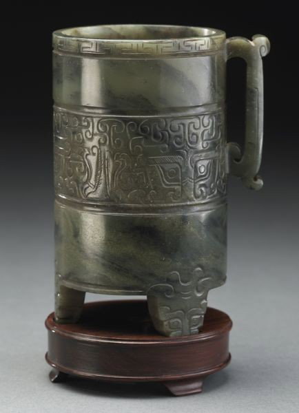 Chinese Qing carved Mughal style jade cup: depicting the face of the beast, on a carved wood stand. Jade: 4.5"H, Circa - 19th C.