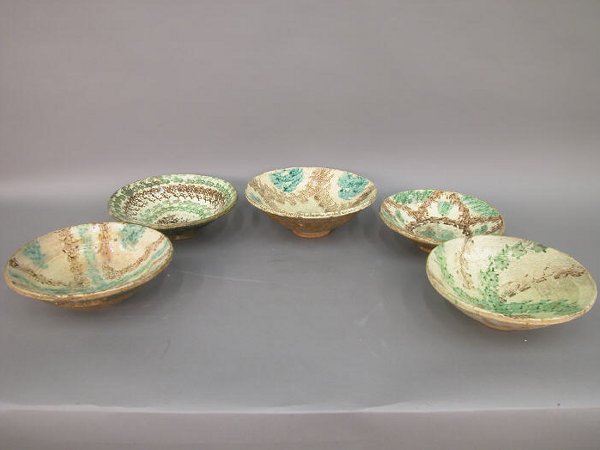 Five French pottery bowls, all worn from