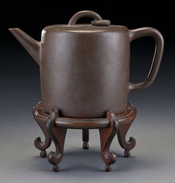 Chinese Qing Yixing clay teapot,: Chinese Qing Yixing clay teapot, with a free ring on the lid, and dragon mark on the base, raised on original rosewood stand. 4.25"H x 6.5"W, Circa - 19th C.