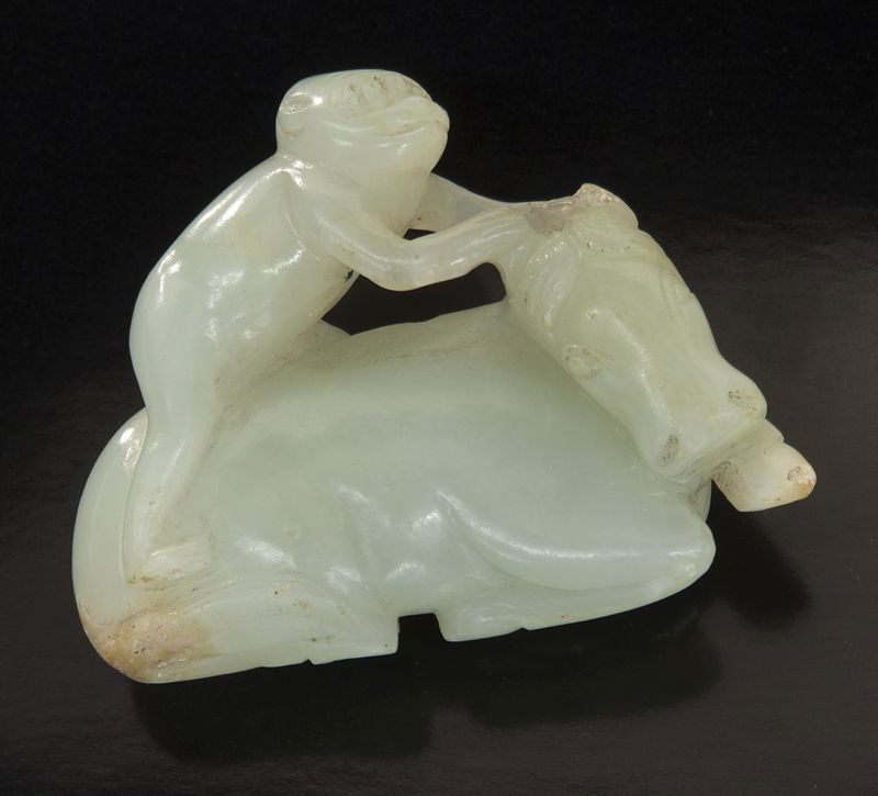 Chinese Qing carved jade toggle: Chinese Qing carved jade toggle depicting a monkey riding on a horse. 1.5"H x 2"W, Circa - 18th - 19th C.
