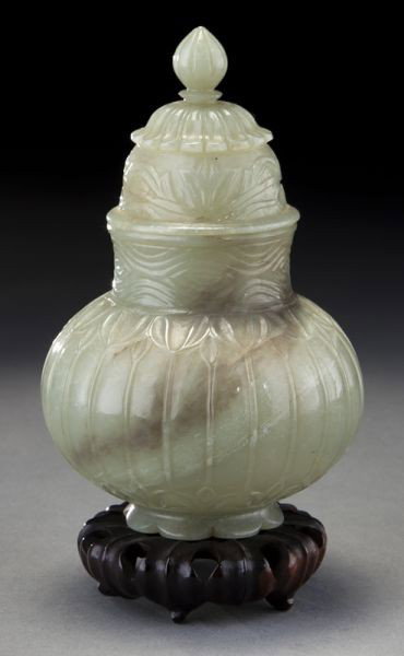 Chinese carved Mughal style jade jar: Chinese carved Mughal style jade jar depicting passion flowers, set in original box. 4.75"H, Circa - Early 20th C.