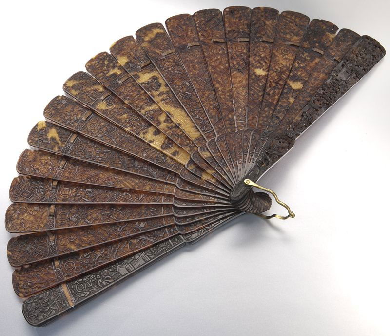 Chinese Qing Canton School carved tortoise shell: Chinese Qing Canton School carved tortoise shell (International shipping IS NOT available on this lot) fan depicting figures in landscapes. 7.5"H x 13.5"W, Circa - 19th C.