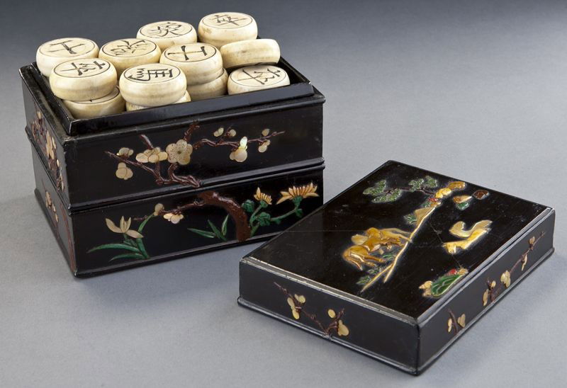 Chinese Qing carved ivory chess set,: Chinese Qing carved ivory chess set, (International shipping IS NOT available on this lot) with incised Chinese characters, set in a mother of pearl and black lacquer box. Each piece: 1.5" Dia.; Box: