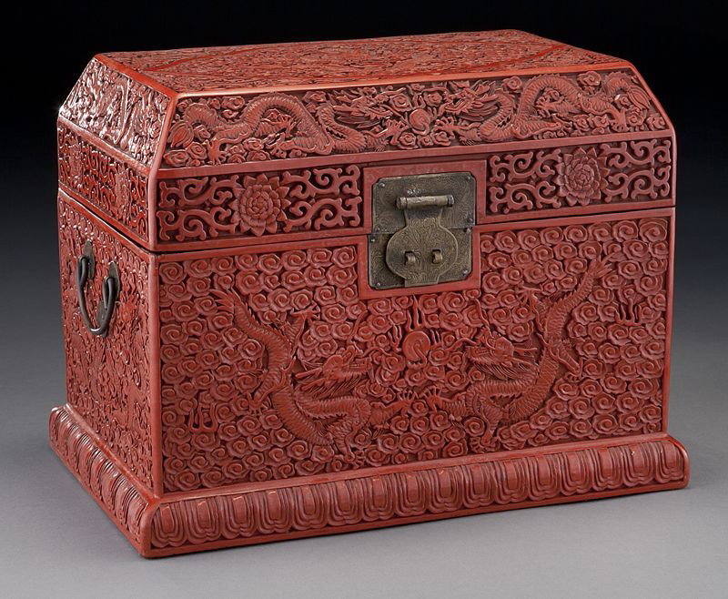 Chinese carved cinnabar seal box: Chinese carved cinnabar seal box depicting dragons chasing the flaming pearl. 11"H x 15"W x 9.5"D, Circa - 20th C.