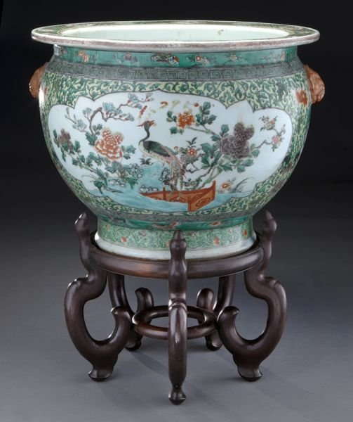 Chinese Republic famille verte porcelain fish bowl: Chinese Republic famille verte porcelain fish bowl depicting bats, birds, and flowers, raised on a carved wood stand. Overall: 24"H, Bowl: 14.5"H x 18.75" Dia., Circa - Early 20th C.