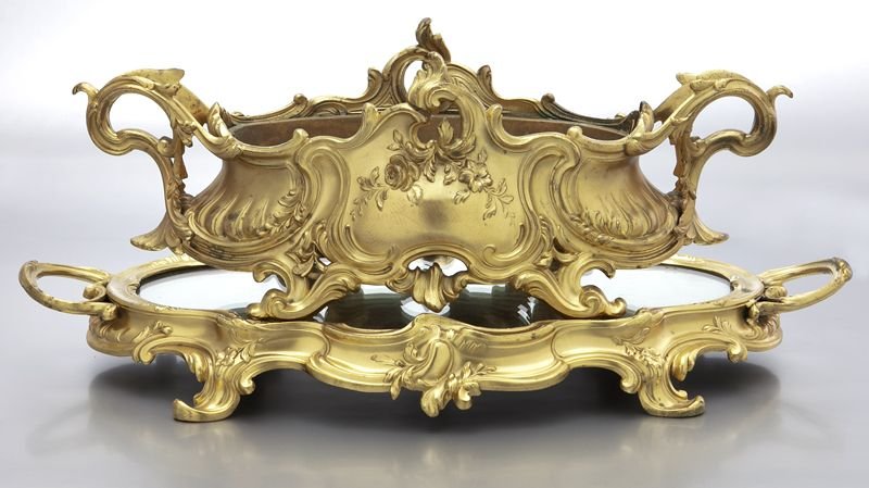 Louis XV style gilt bronze centerpiece: Louis XV style gilt bronze centerpiece resting on a mirrored stand, both with pierced handles, decorated with rocaille scrolls and flowers, the centerpiece fitted with a liner. Marked, "Depose". 17.5'