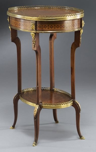 Napoleon III ormolu and marquetry side table,: Napoleon III ormolu and marquetry side table, the upper and lower tiers having an oval band of marquetry inlay and a pierced gallery, the apron with a single drawer frieze, raised by cabriole legs end