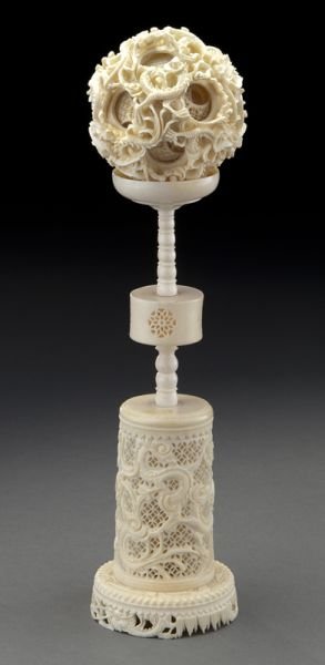 Carved ivory puzzle ball depicting dragons: Carved ivory puzzle ball depicting dragons (International shipping IS NOT available on this lot. This lot may not be purchased by a resident in the state of California). 10.5"H, Circa - Early 20th C.
