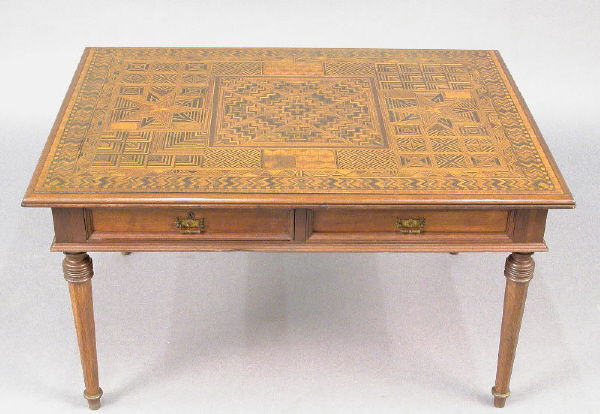 Coffee table w/ intricately inlaid mixed wood top: Coffee table w/ intricately inlaid mixed wood top in varying and finely worked geometric patterns. Table has four drawers, two of which are false drawers and stands on octagon shaped and tapering legs