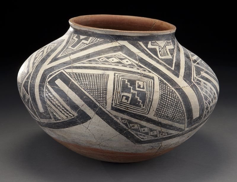 Gila polychrome terracotta jar: Gila polychrome terracotta jar having a slightly flared lip, the body having a white ground with geometric design and cross hatching in black. Repairs. 10''H, Circa - 1000-1200.
