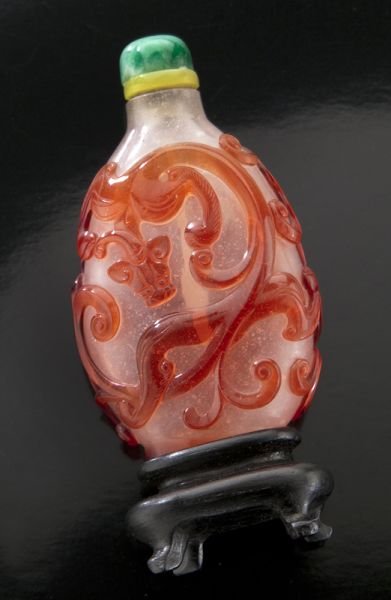 Chinese Qing ruby red overlay Peking glass: Chinese Qing ruby red overlay Peking glass snuff bottle depicting double chi-dragons. 2.75"H, Circa - 18th C.