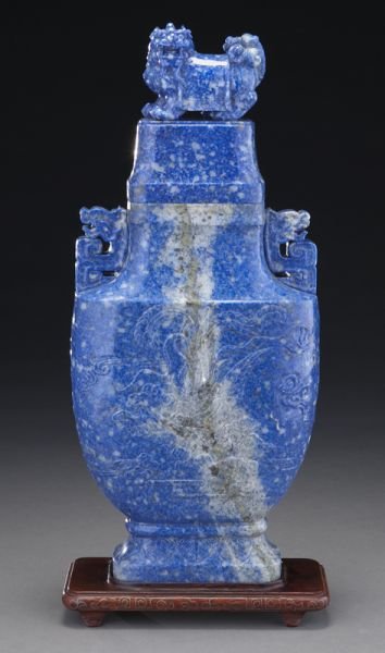 Large Chinese carved sodalite vase: Large Chinese carved sodalite vase depicting dragons, phoenix and lions, raised on a silver inlaid rosewood stand. 16.75"H, Circa - 20th C.