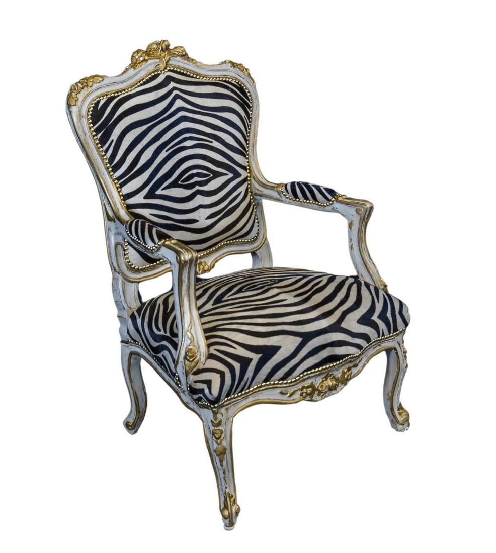 Oversized wooden and zebra hair chair.: Carved wooden frame with gold highlights, zebra skin back, seat and arms. H 42.5 W 22 D 25 in H 42.5 W 22 D 25 in