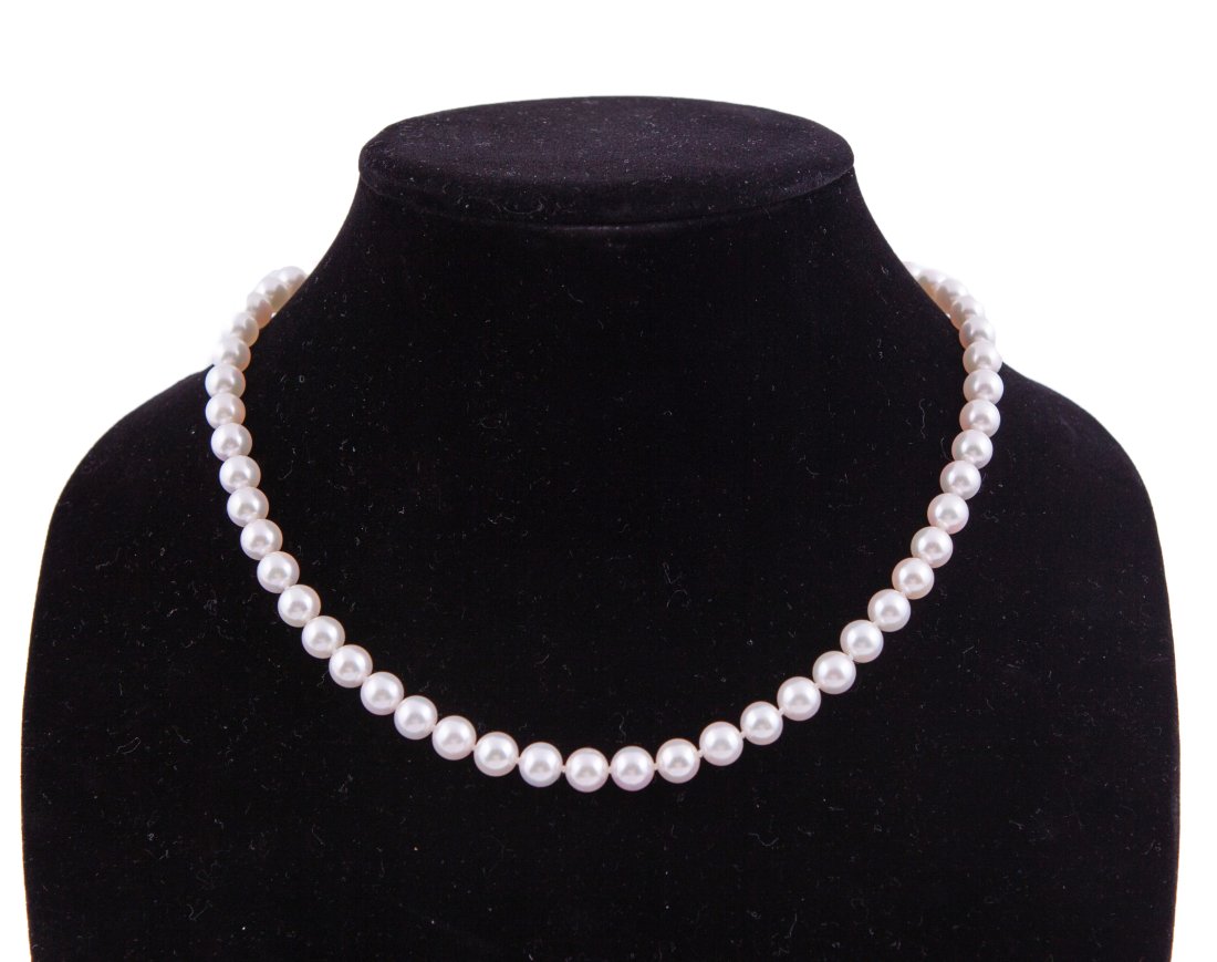 Mikimoto Strand of Pearls: White pearls with white gold clasp. Measuring 17 in. long. Comes with original box and bag.