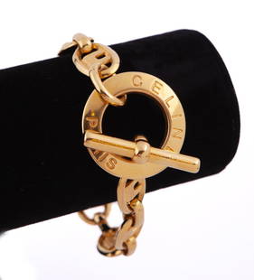 Celine Link Bracelet: Gold tone bracelet with toggle lock.