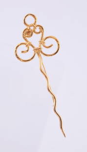 Celine Brooch: Gold tone scrolling brooch. Measuring 5 inches long.