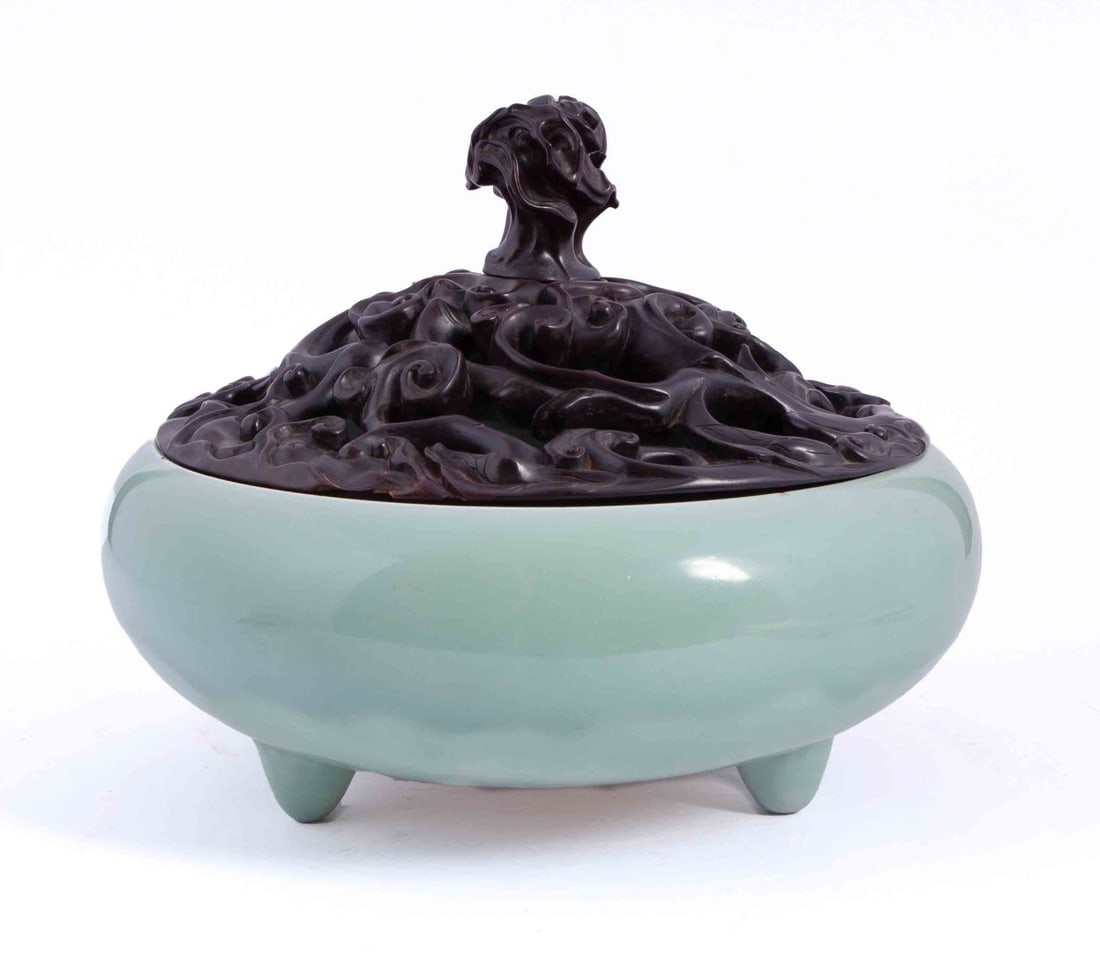 Chinese Qing Celadon Porcelain Incense Burner: With a carved hardwood openword lid, depicting a scrolling Lingzhi. 18th-19th Century Circa. Measuring: H 12.5 W 16 D 16 in.