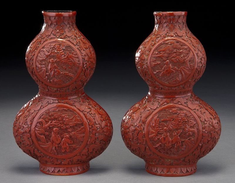 Pr. Chinese Qing carved cinnabar double gourd: Pr. Chinese Qing carved cinnabar double gourd shaped wall bracket vases, depicting figures in a landscape. 8.25"H x 5"W, Circa - 19th C.