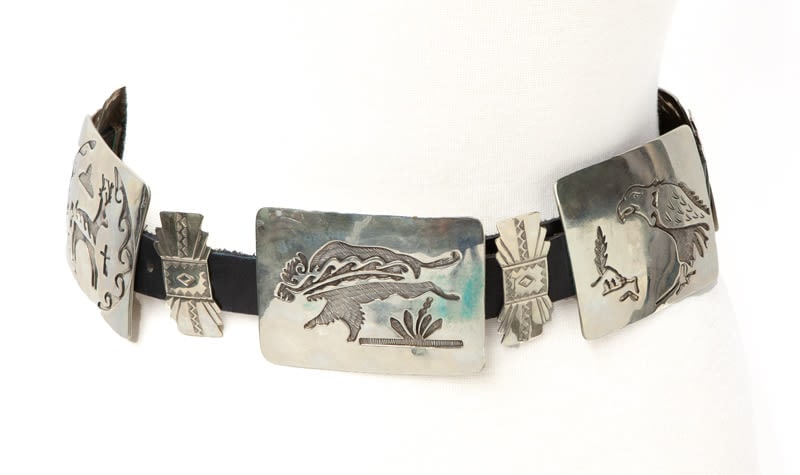 Mexican sterling and leather belt: having six slides featuring stylistic animals alternating with six bow-form slides. Stamped, "Mexico". 