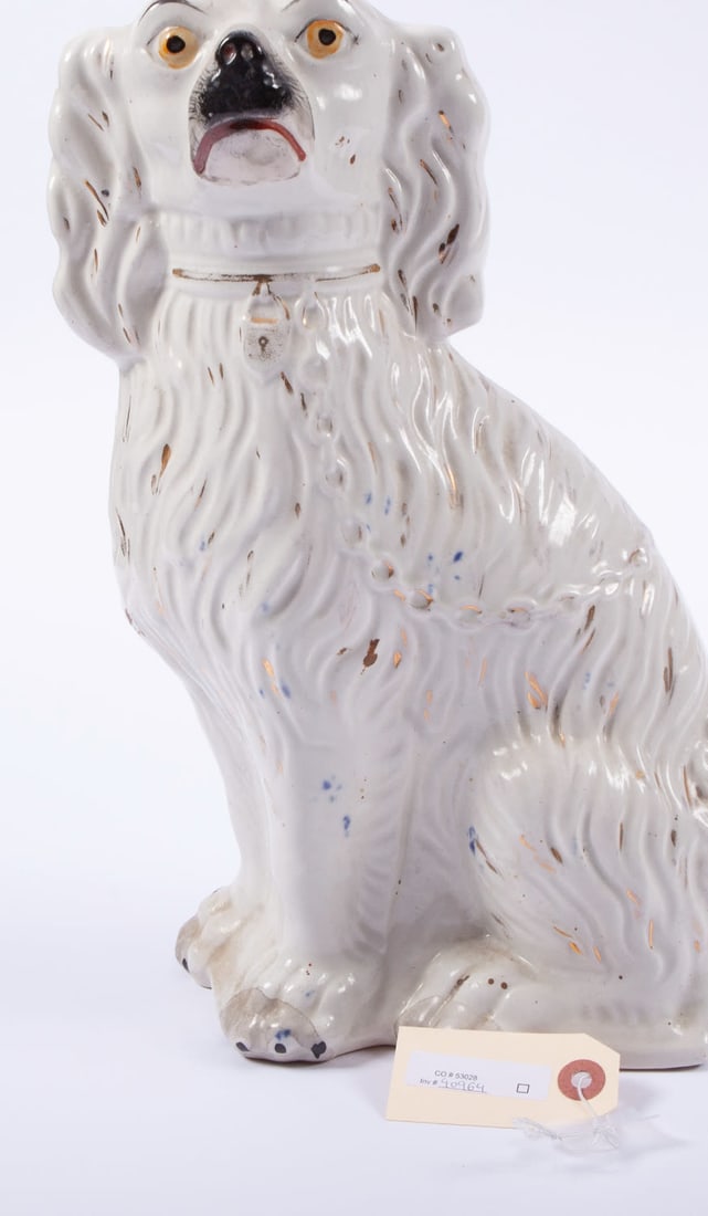 Pair of English Staffordshire Dog: Painted white, yellow eyes with lock and chain detail. Measuring H 13 in Provenance: Private Dallas collector No reserve