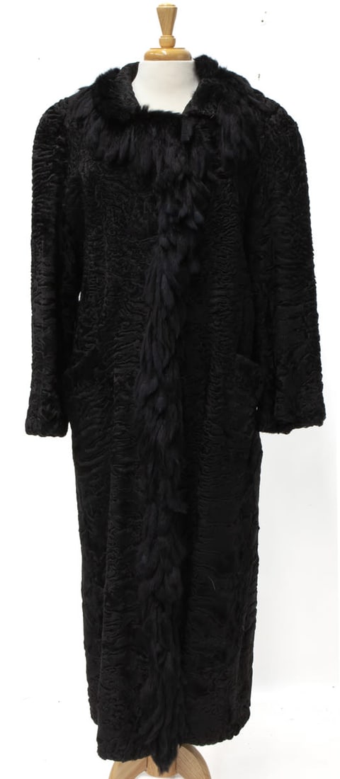Reichbind Furs Luxury Fur Coat: Black Astrakhan with classic young lamb pattern. Long cut coat with fine tassel decor and long sleeves. In excellent condition, marked Reichbind Furs, Orange Connecticut. Measuremets: