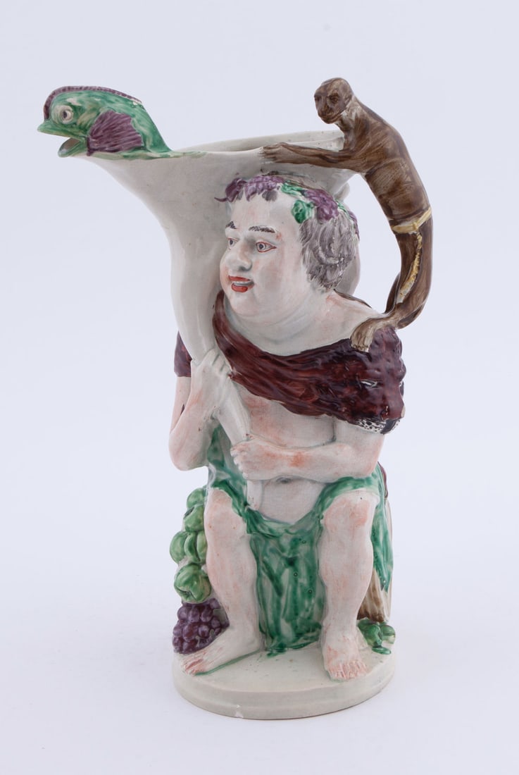 Fine Creamware Bacchus and Pan Pitcher: French creamware jug depicting Greek gods Bacchus and Pan. Unmarked, measuring H 13 W 8.5 in Some minor chips to the edges. Provenance: Floyd and Beverly Sherman's Private Collection No reserve