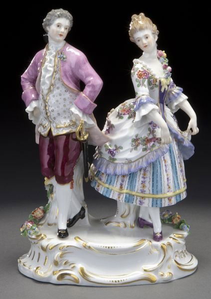 Meissen porcelain figural group of a fancily: Meissen porcelain figural group of a fancily dressed couple dancing on a platform rocaille base accented by applied flowers. Cross swords mark in blue under glaze, as well as impressed, incised and ov