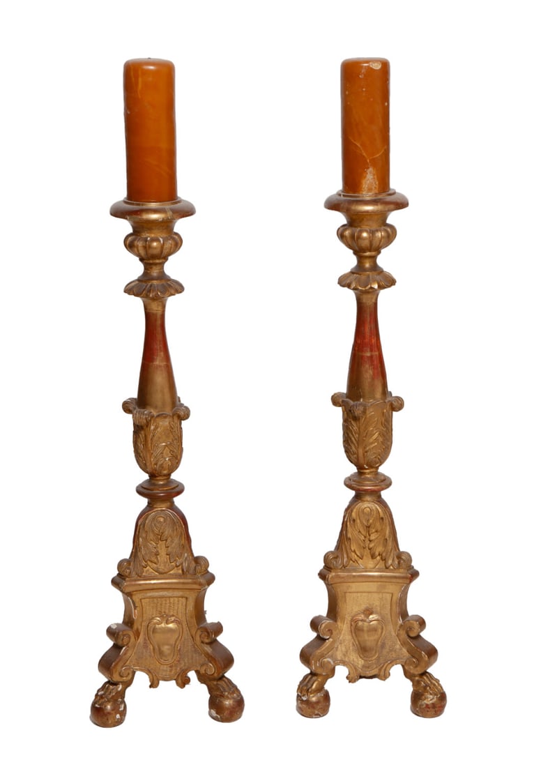 Pair of Italian Style 19th Century Gilt Candlesticks: Beautiful carved wood gilt candlesticks with botanical details and crests with two wax candles. Measuring H 33 without the candles, H 42 with the candles. Some chips and cracks.