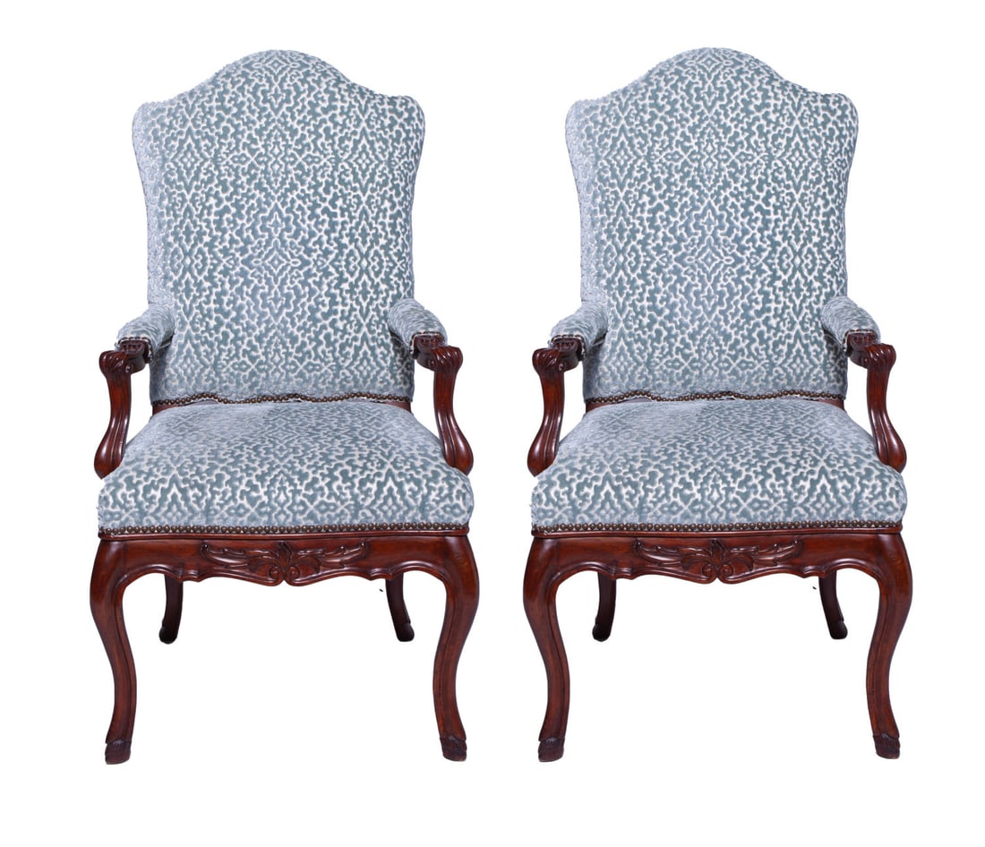 Pair of Carved Mahogany Armchairs: Pair of antique mahogany armchairs with carved acorn leaves decor on arms and frame. Recently upholstered with contemporary light blue velvet pattern on back, seat and arms. Measuring H 47 W 24 D 22 i