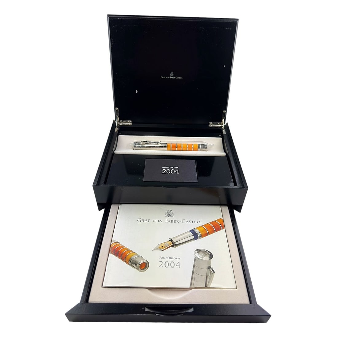 Graf Von Faber Castell Pen: 2004 Pen of the Year - Silver toned pen with orange enameled details. Complete with original packaging and papers.
