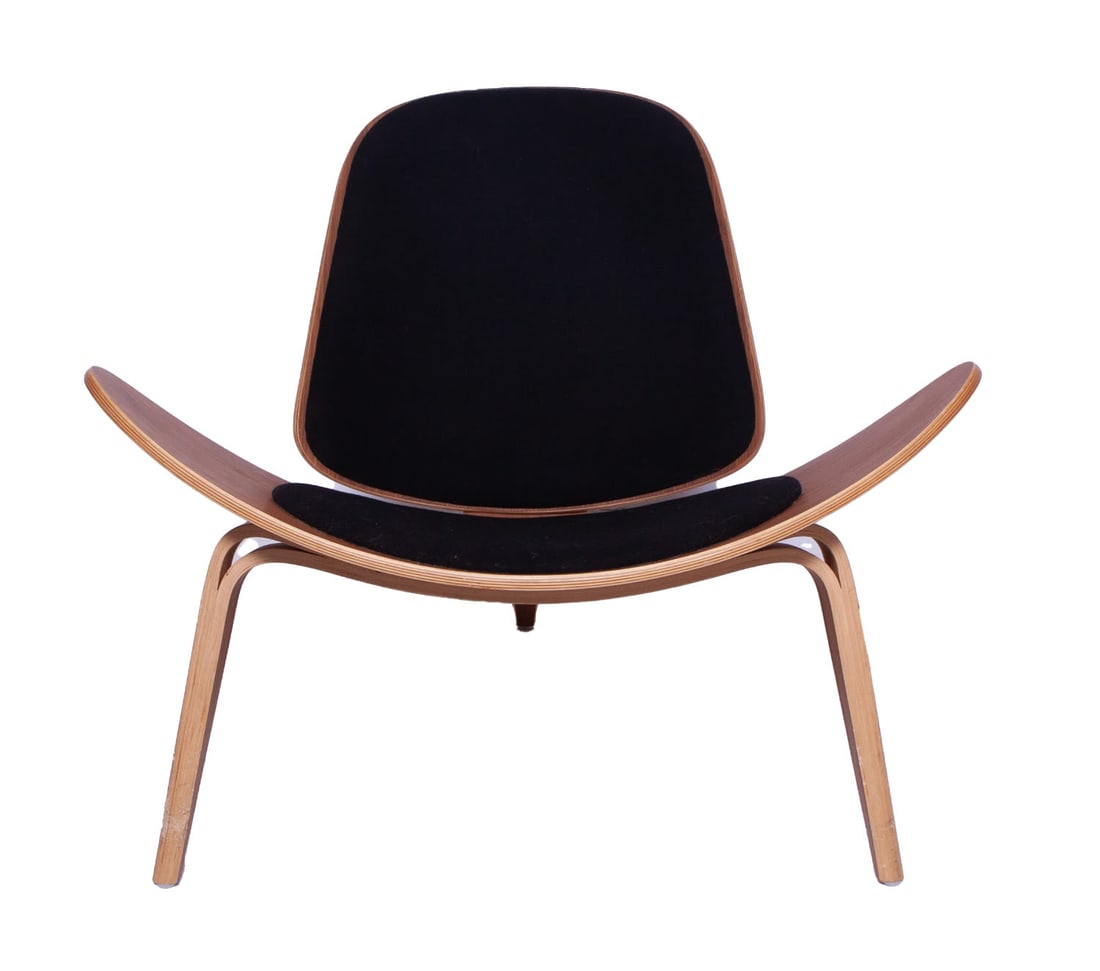Mid-Century Style Shell Lounge Chair: Classic mid-century design lounge chair with shell shaped upholstered seat and back in black fabric on light wood. Measuring H 30 W 36.5 in Some damage to the legs. 