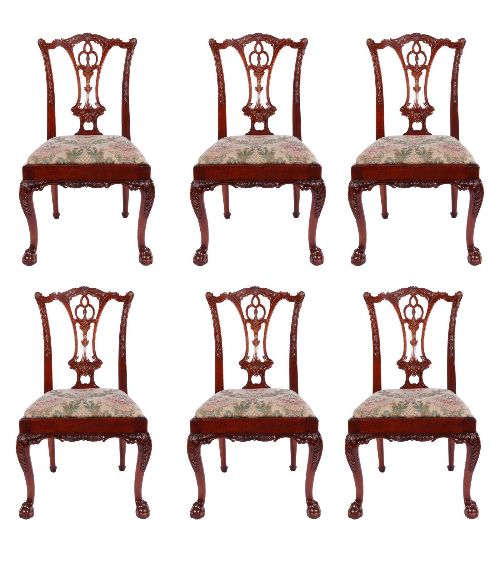 Set of Six Chippendale Style Carved Mahogany Chairs: Six dining chairs in Chippendale style with elegant carved backs. The seats are upholstered and decorated with beautiful botanical patterns in pastel tones. In great condition, slight wear consistent