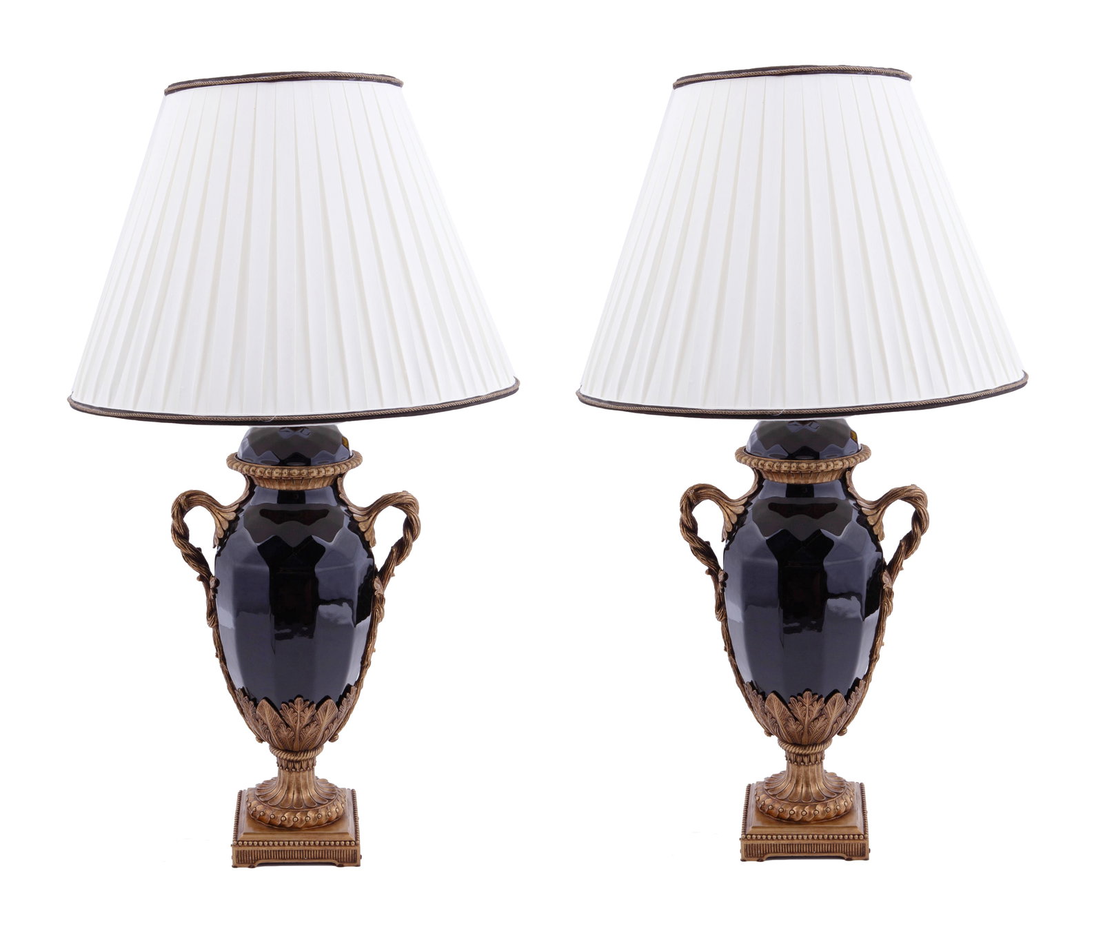 Pair Of Neo Classical Lamps With Shades: Two neo-classical electrified lamps in glossy back with gold tone brass appliques on a decorated brass bases in botanical motif. Each completed with a white plisse shades decorated with black and gold