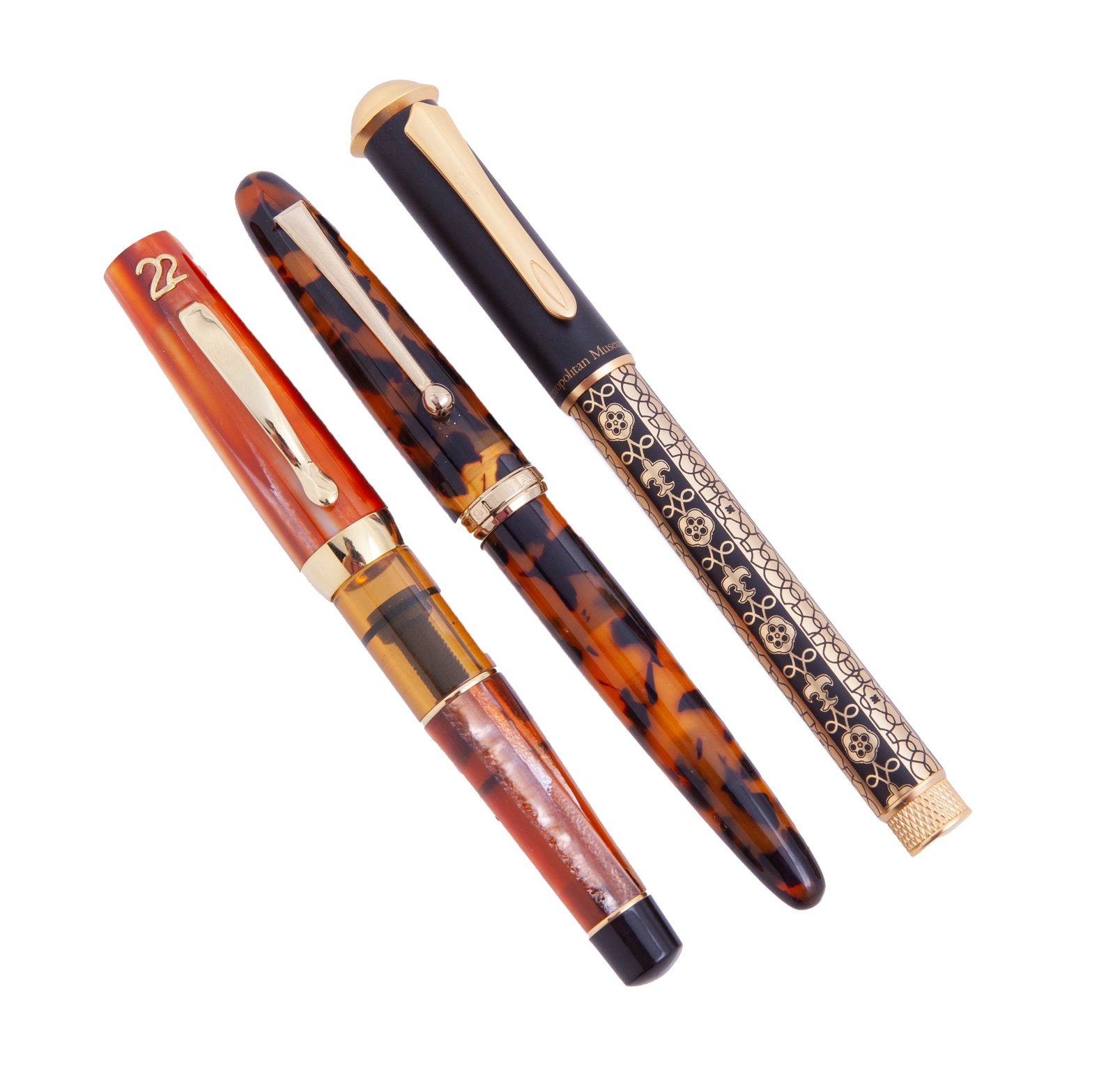 Collection of Three Fountain Pens: Including: - Gold and black MET Museum commemorative fountain pen, decorated with fleur de lis and geometrical details. - Sailor Japan 1911 in tortoiseshell with gold tone ring and clip, featuri