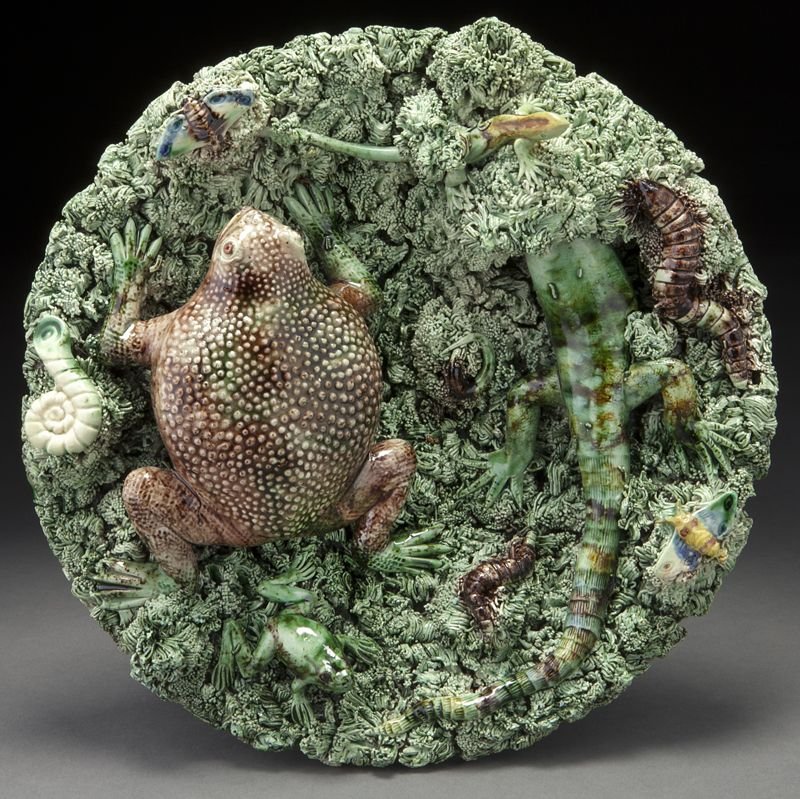 Portuguese palissy dish by Jose Alves Cunha,: Portuguese palissy dish by Jose Alves Cunha, centered by a toad and lizard on a mossy ground, surrounded by various insects. Stamped to base "Jose A. Cunha Portugal Caldas Rainha". 10.75'' Dia., Circa
