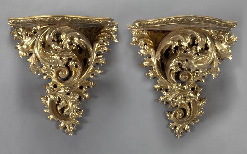 Pr. impressive Italian carved gilt wood wall: Pr. impressive Italian carved gilt wood wall brackets with shaped tops over acanthine scrolled supports. 21.5''H x 20''W, Circa - Late 19th - Early 20th C.