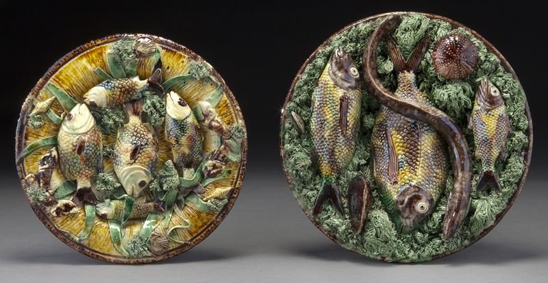 (2) Portuguese palissy dishes with fish, incl:: (2) Portuguese palissy dishes with fish, incl: (1) applied with an eel slithering across three fish, on a mossy ground. With impressed mark to base "M. Mafra Caldas Portugal" and incised "5"; and (1) 