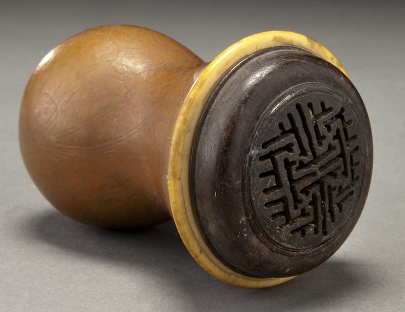 Chinese Qing carved gourd cricket cage: Chinese Qing carved gourd cricket cage (International shipping IS NOT available on this lot. This lot may not be purchased by a resident in the state of California for resale) with a banded ivory rim.