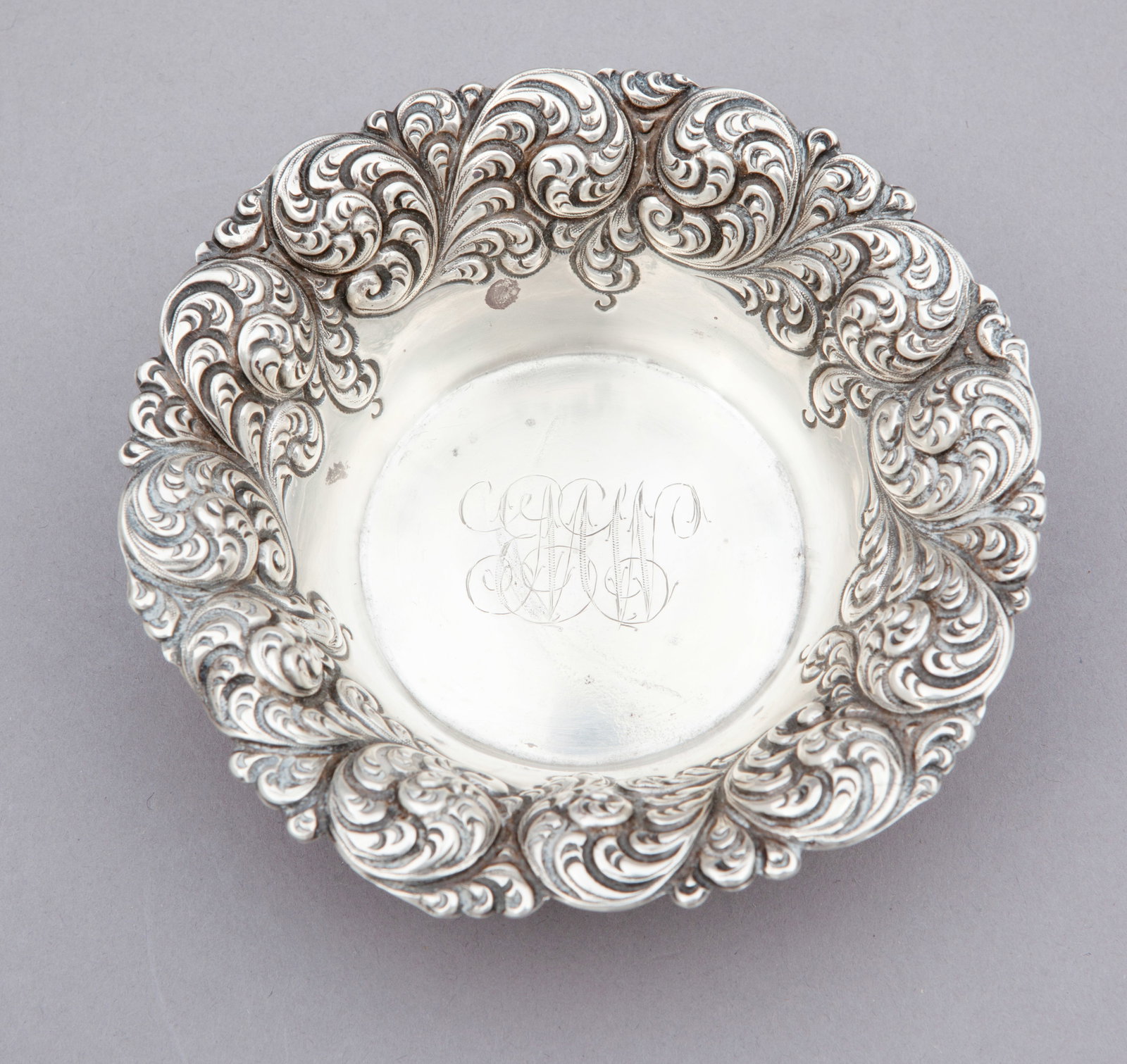 Reed & Barton Burgandy Nut Dish: With decorated rim and monogram in the center. Marked on underside. Measuring 5 inches wide. Weight 66 g